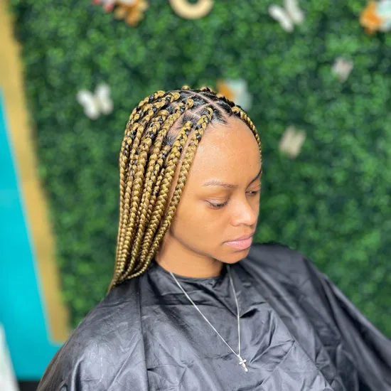 Mid Part Blond Knotless Braids with Black Roots
